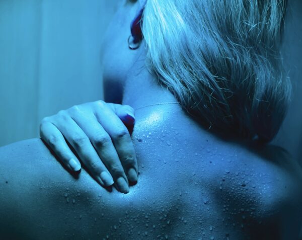 a woman touches her back where she has pain