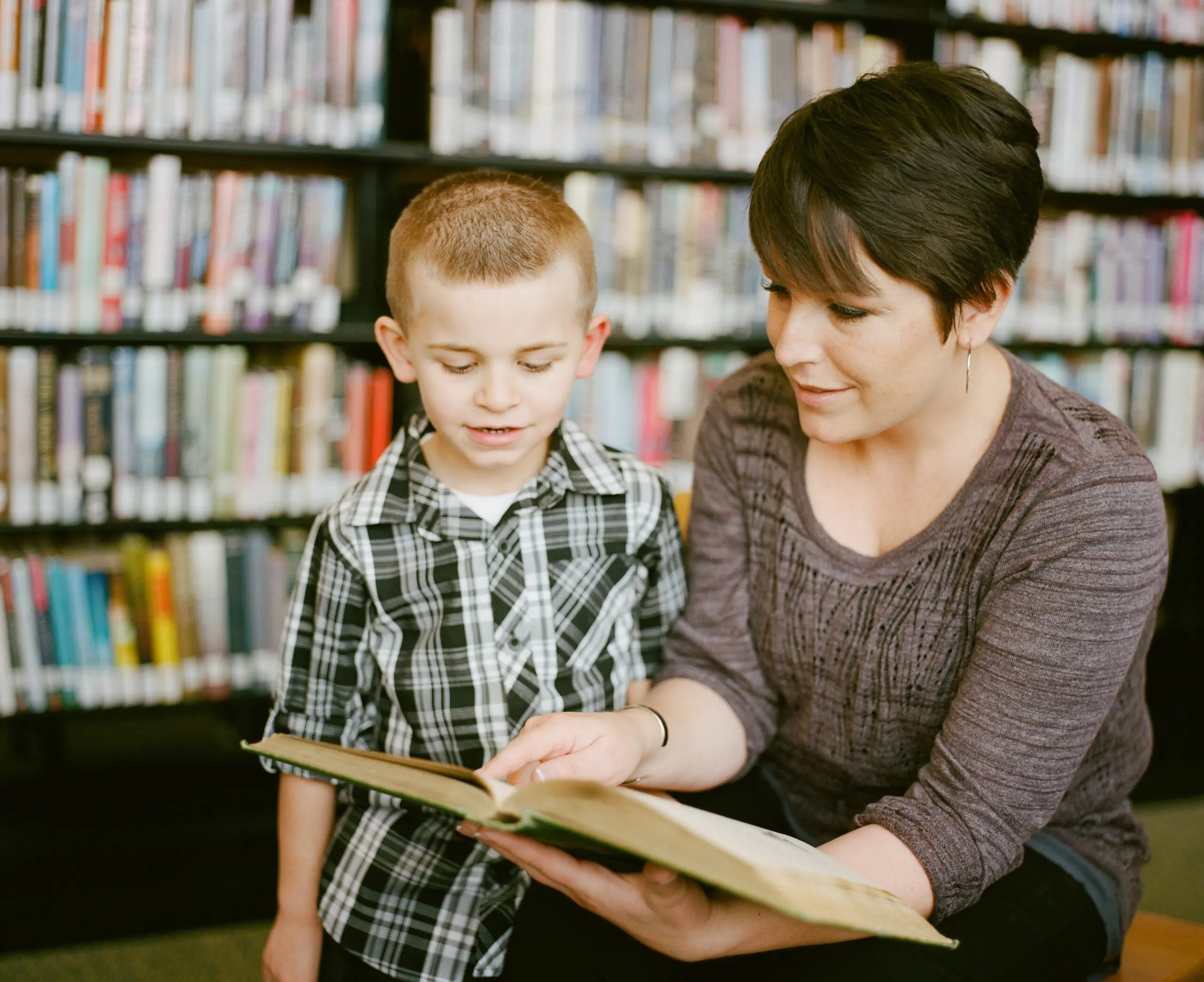 a teacher reads to a non-speaking learner
