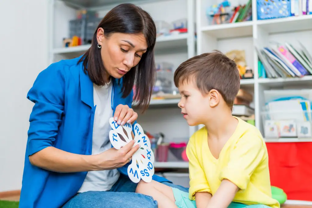 a woman teaching a child with flash cards