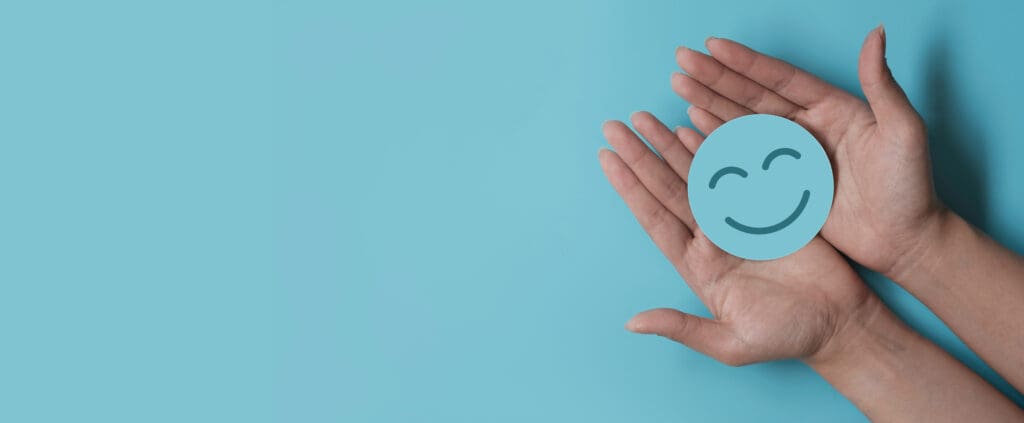 a smiley face held in a person's hands