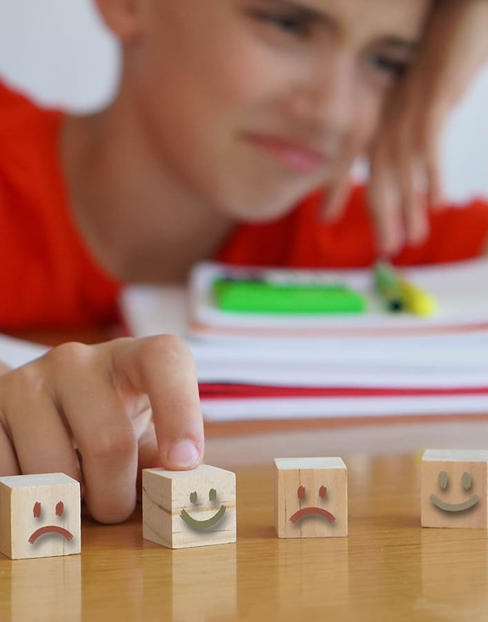 Pre-adolescent child student with color feeling blocks