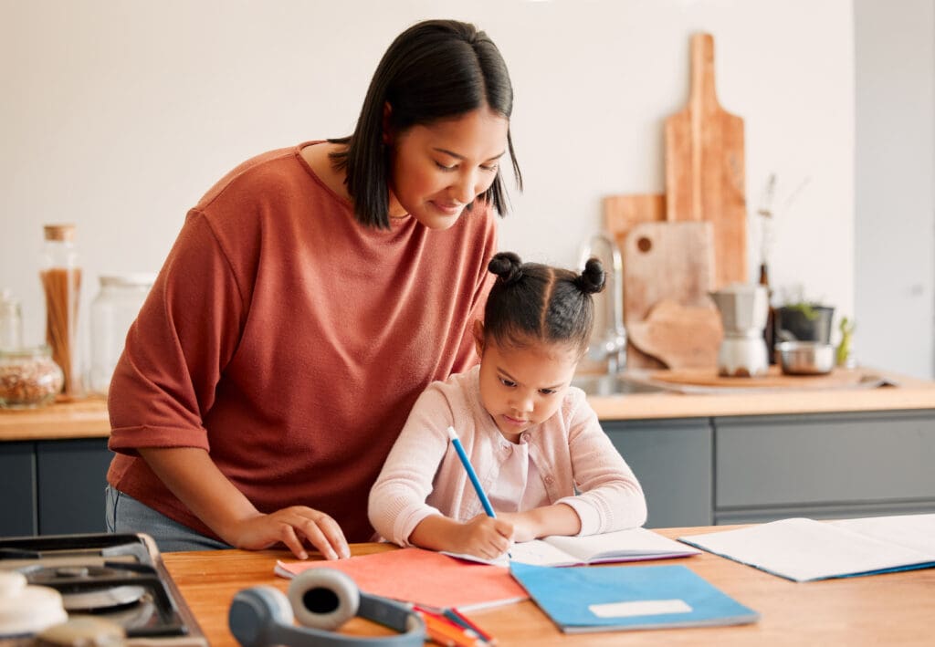 Mother teaching daughter at home